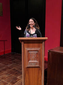 Jennifer at a podium speaking